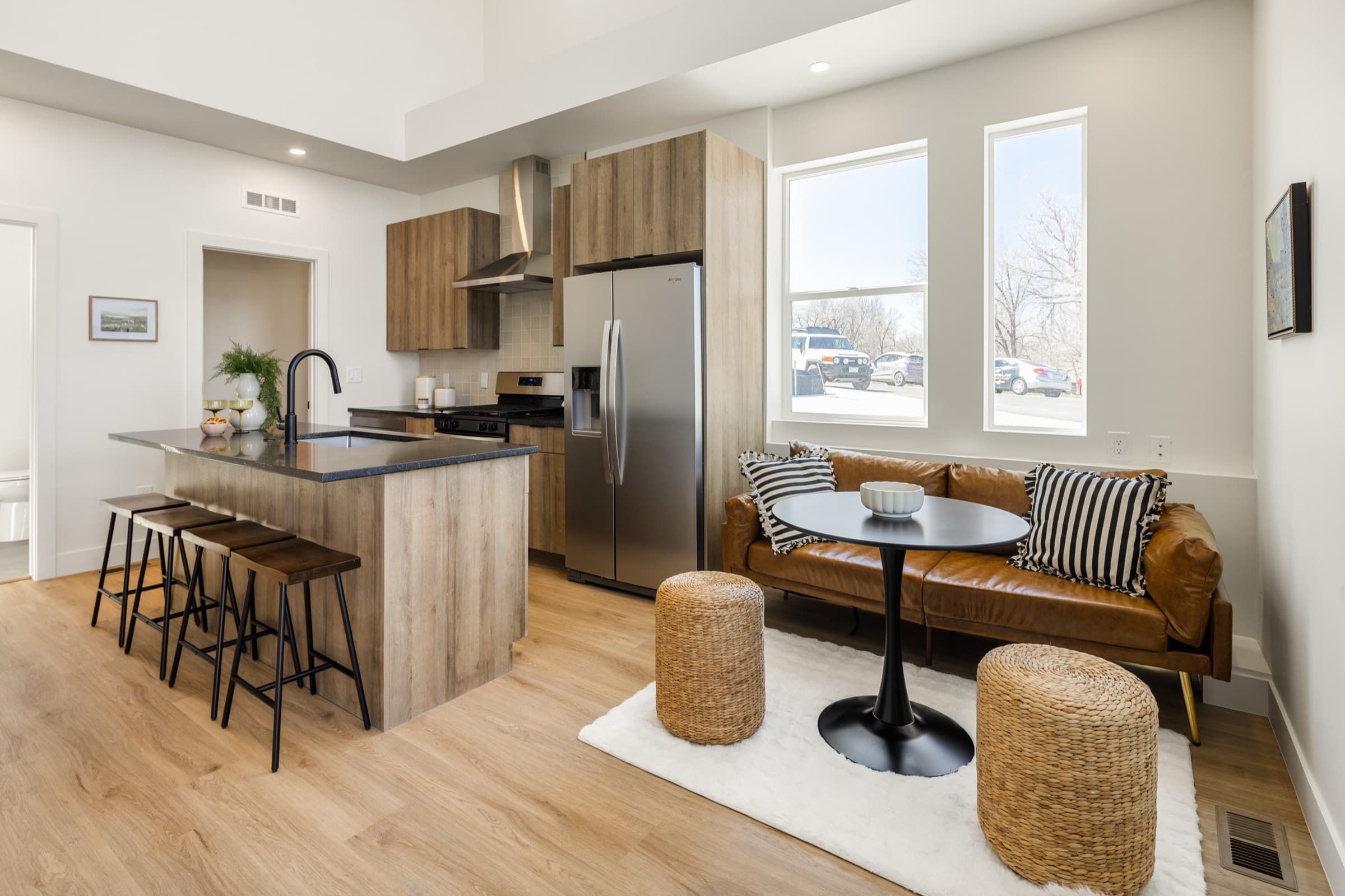 Open kitchen and dining area with white walls and oak floors