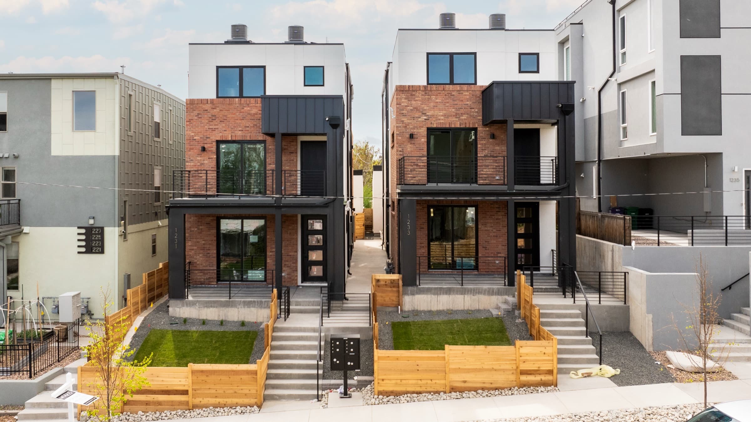 Two finished townhome buildings facing a new front walk