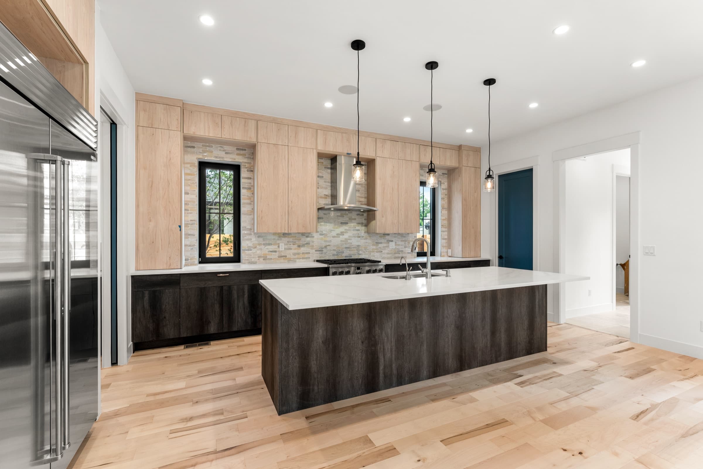 Range wall, maple uppers and stacked-stone backsplash